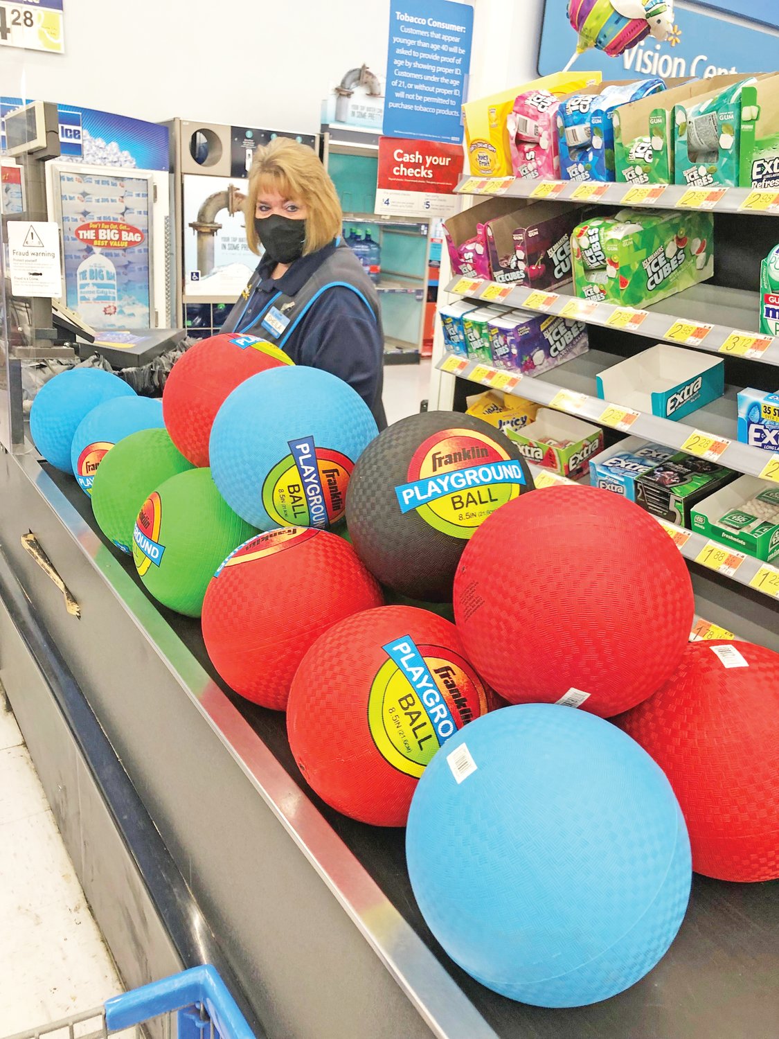 A Walmart cashier rings up playground balls donated by Wabash Avenue Presbyterian Church to Afghan refugees being housed at Camp Atterbury.