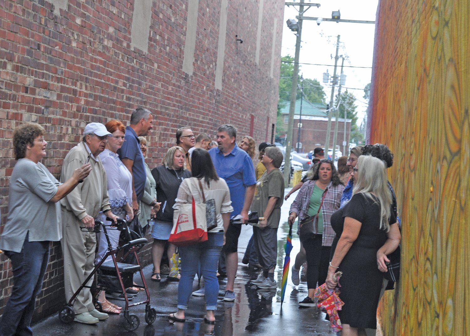 People gather in the alley between the Montgomery County Community Foundation and Milligan