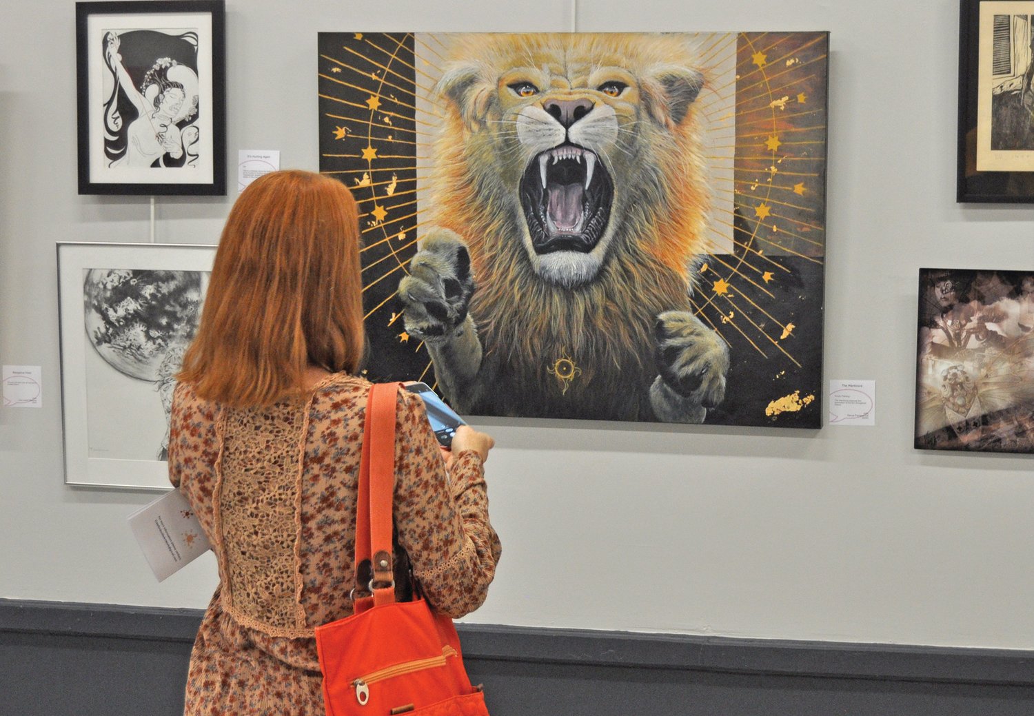 Wendy Schmitzer-Torbert looks at a painting in the Athens Arts Gallery on Saturday. The gallery was a stop on the Art Walk sponsored by the Montgomery County Art League.