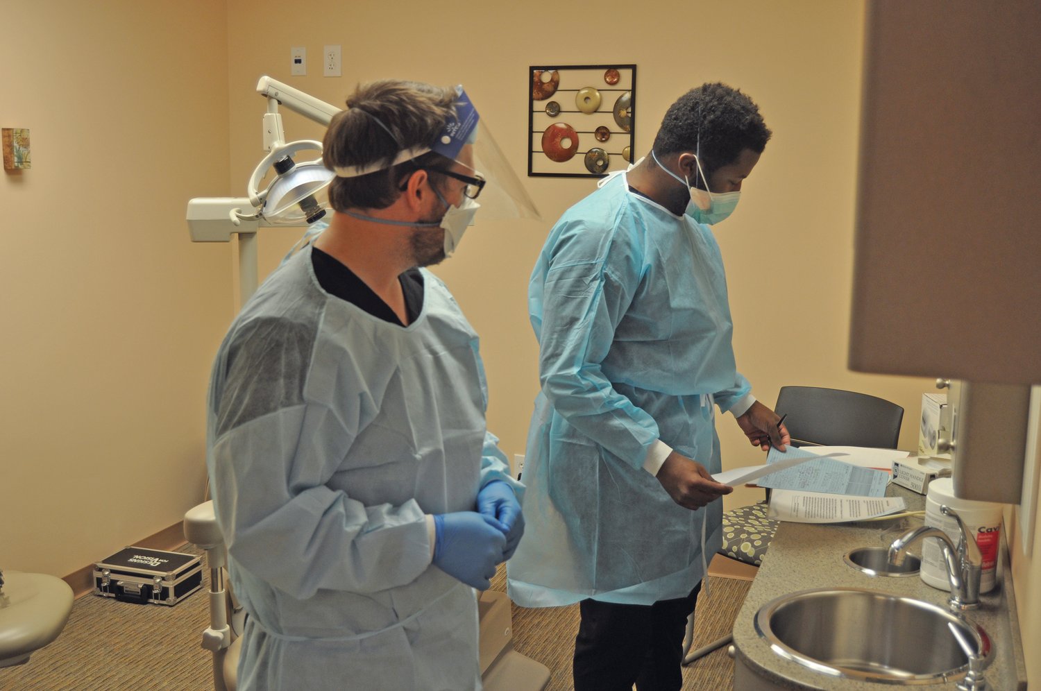 Dental students Phillip Lane, right, and Richard Gunnell prepare for the next patient at the Dr. Mary Ludwig Montgomery County Free Clinic on Saturday. The dental school in Indianapolis has partnered with the clinic to treat urgent dental needs.