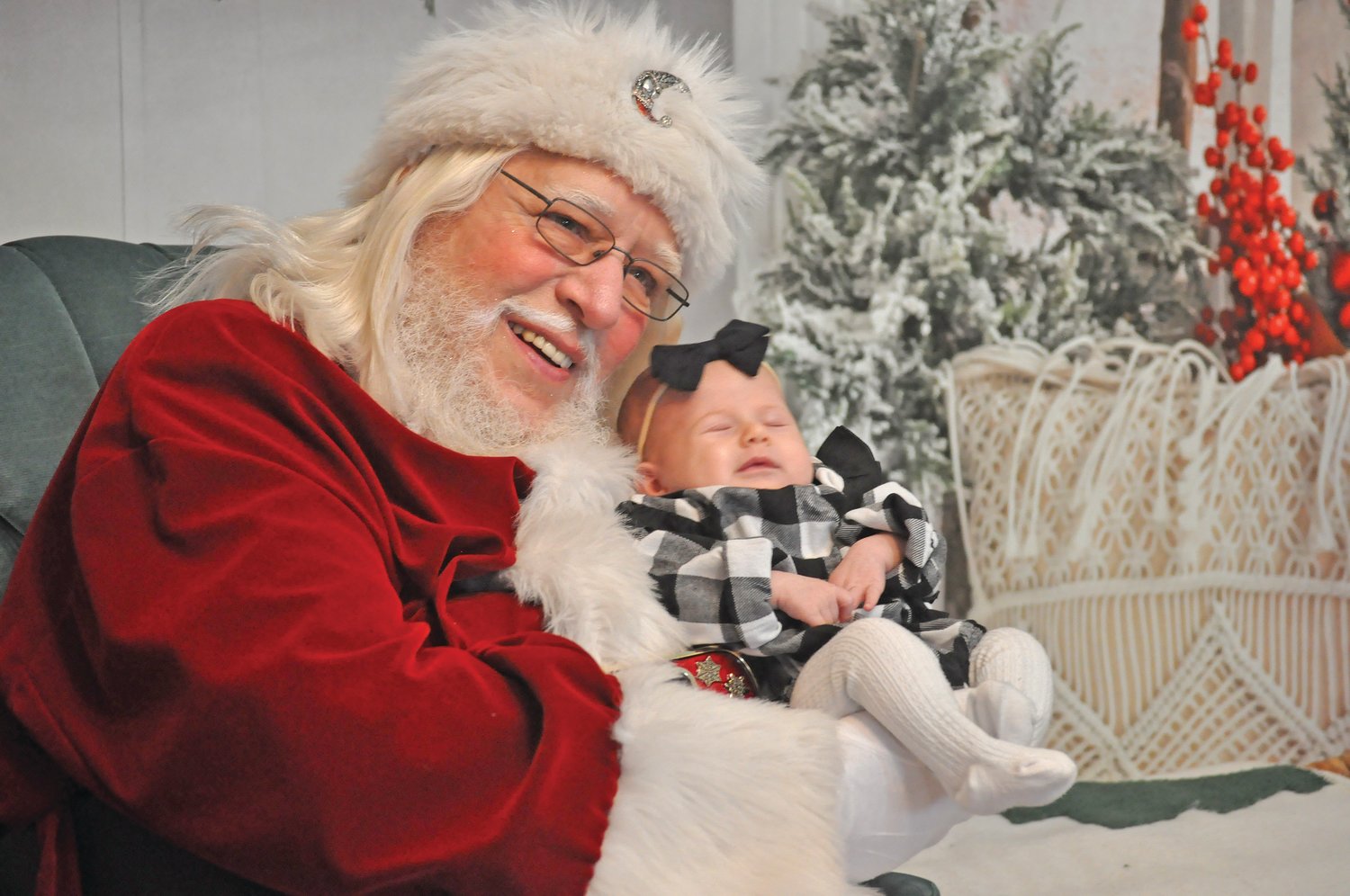 Santa Claus holds 2-month-old Emery Gwynn at The Santa Experience at Abbey Elaine Photography Saturday. The studio offered photos with Santa during Small Business Saturday and Downtown Party Night activities in downtown Crawfordsville.