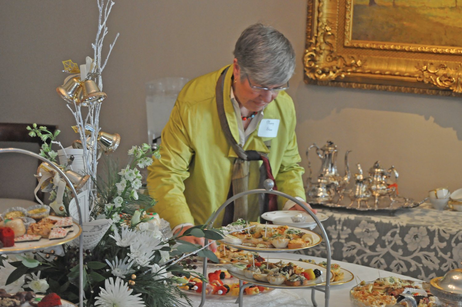 Nancy Stone selects a refreshment at the Sounds of the Season Holiday Tea & Fashion Show at the Elston Homestead Friday. The fundraiser for the General Lew Wallace Study & Museum featured an interactive fashion show featuring local models wearing fashions from heathcliff.