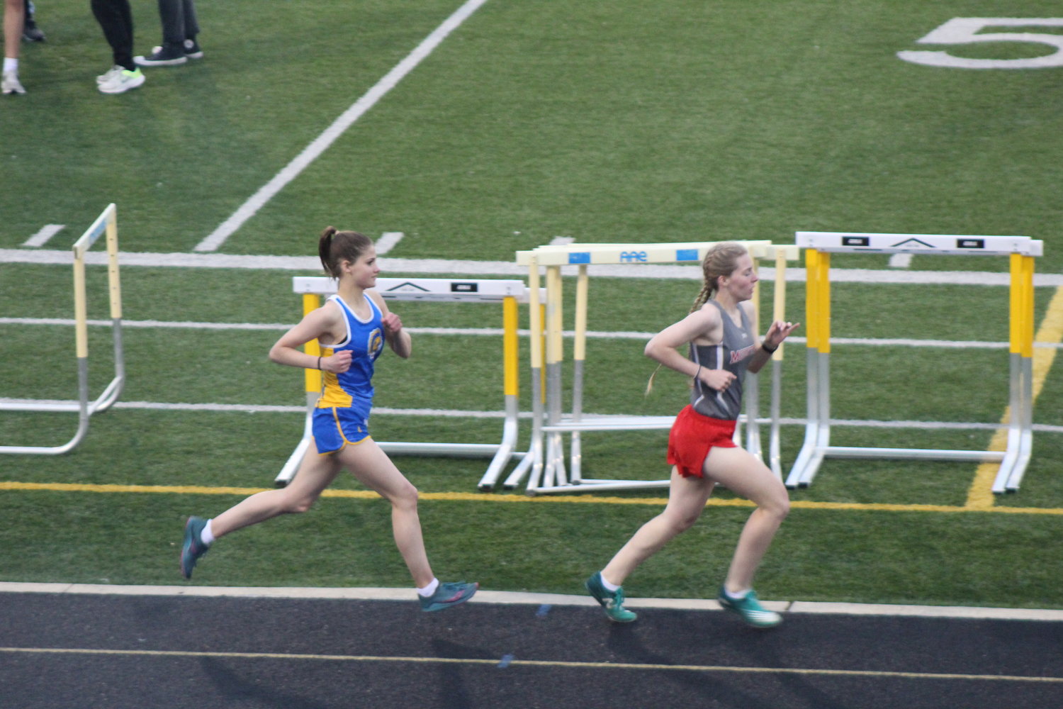 Crawfordsville’s Sophia Melevage and Southmont’s Faith allen keep pace with one another in the 1600 meter run at the Athenian Invite. Melevage would surpass Allen for the win.