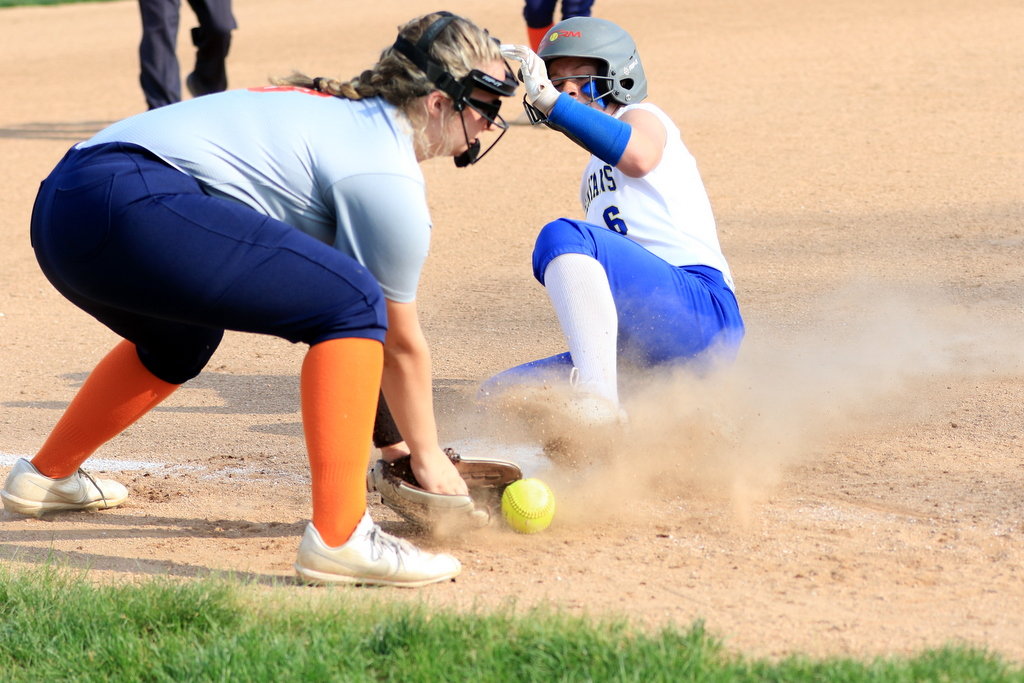 North Montgomery's Mallory Morehouse prepares to make a tag on Crawfordsville's Celeste Moore sliding into third base.